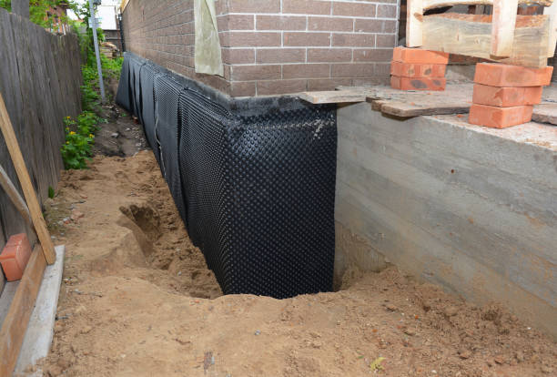 SJ Waterproofing Pros technician performing targeted Interior Drainage System assessment in Whitewater, KS